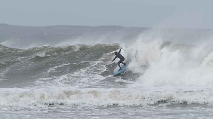 A surfer moving through the waves at Enniscrone. Photo: Anthony Hickey